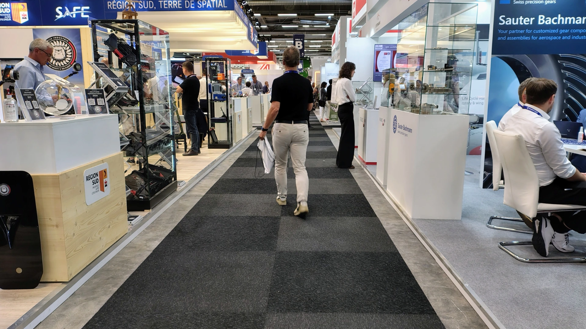 Trade show floor with hundreds of booths and visitors walking past stands without stopping